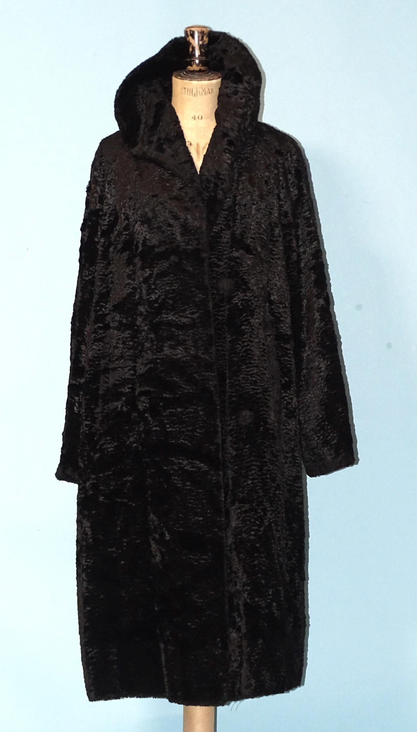 A faux Astrakhan coat, an early-20th century black crepe coat, a later leather/sheepskin