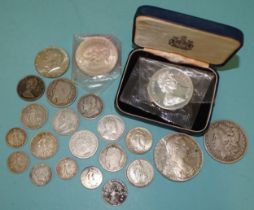 A small collection of silver world coins, including a USA 1879 dollar, a 1968 half-dollar, Bermuda