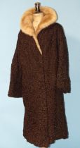 A 1950's brown Persian lamb coat with fur collar.