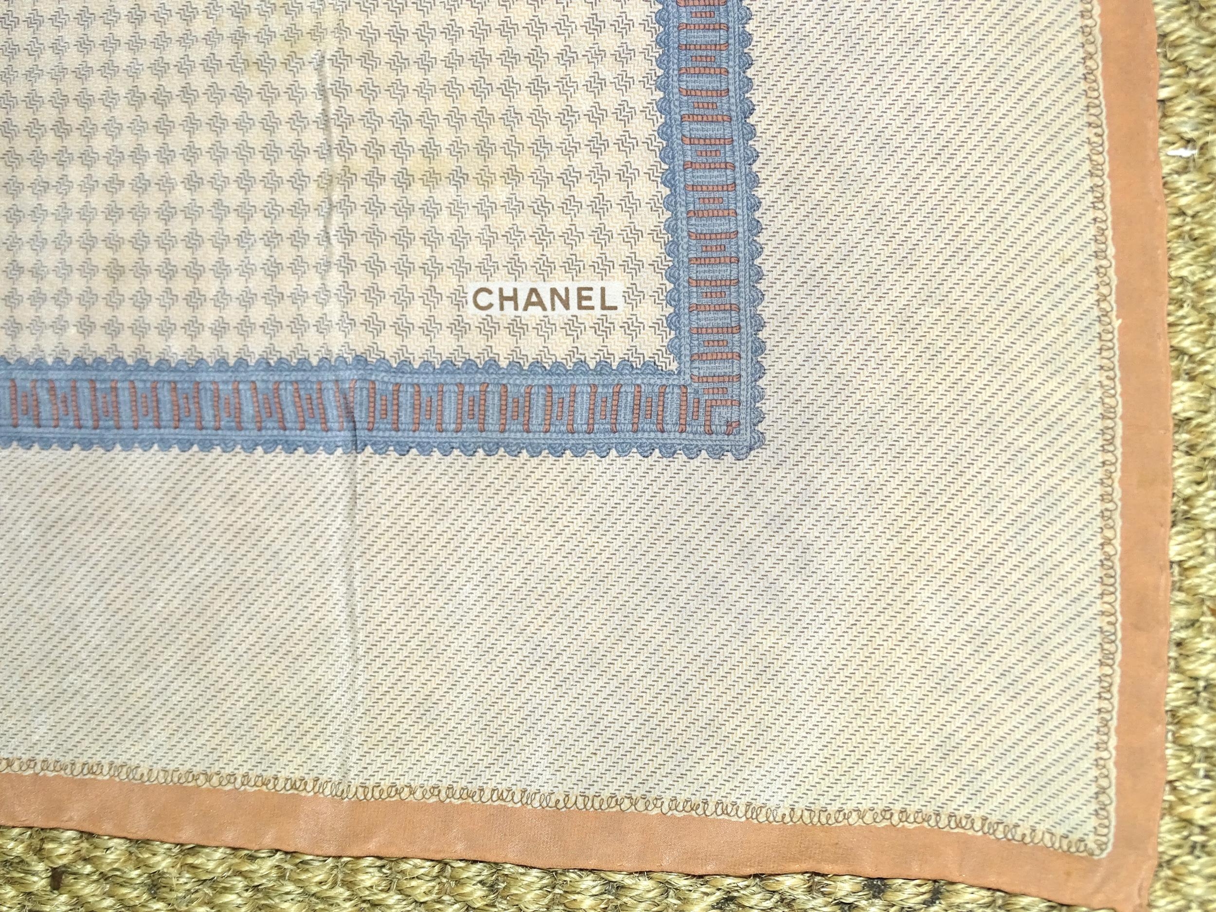 Chanel, a silk scarf in muted apricot and blue on a light background, 86cm square. - Image 2 of 2
