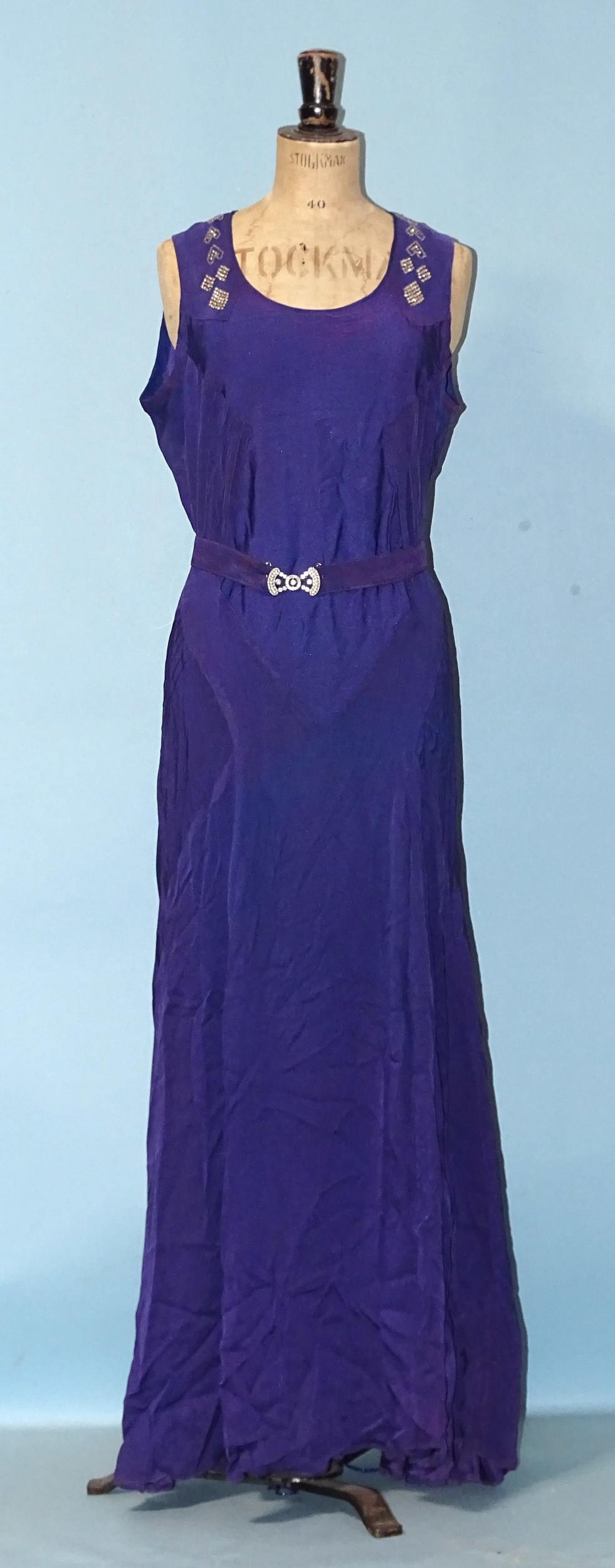A 1930's evening dress of purple satin-like material, sleeveless, with hand-beading to neckline, the