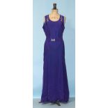 A 1930's evening dress of purple satin-like material, sleeveless, with hand-beading to neckline, the