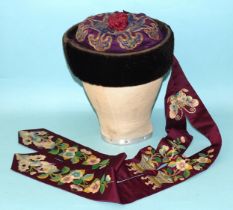 A rare 19th century embroidered silk Chinese hat, the padded purple silk crown overlaid with a