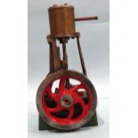 A single-piston vertical stationary engine with flywheel, unmarked, 19.5cm.