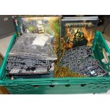 A collection of Warhammer items, including plastic and metal figures, unmade plastic kit pieces on