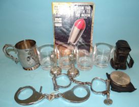 A vintage Lucas cycle lamp with red glass, 12cm high, a pair of vintage Hiatt handcuffs with key