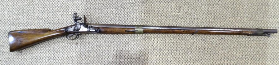 A flintlock musket, with 105cm barrel and full-length walnut stock, brass trigger guard and butt