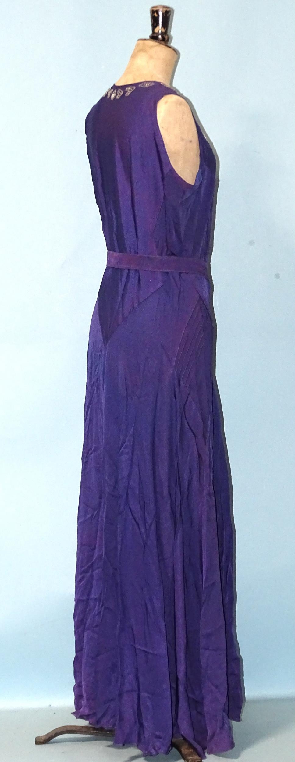 A 1930's evening dress of purple satin-like material, sleeveless, with hand-beading to neckline, the - Image 2 of 5