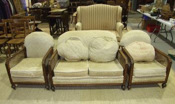 A mid-20th century stained wood and caned Bergère suite, comprising a two-seater settee and two