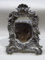 A modern sterling silver shaped mirror with cherubs and floral decoration, stamped Sterling