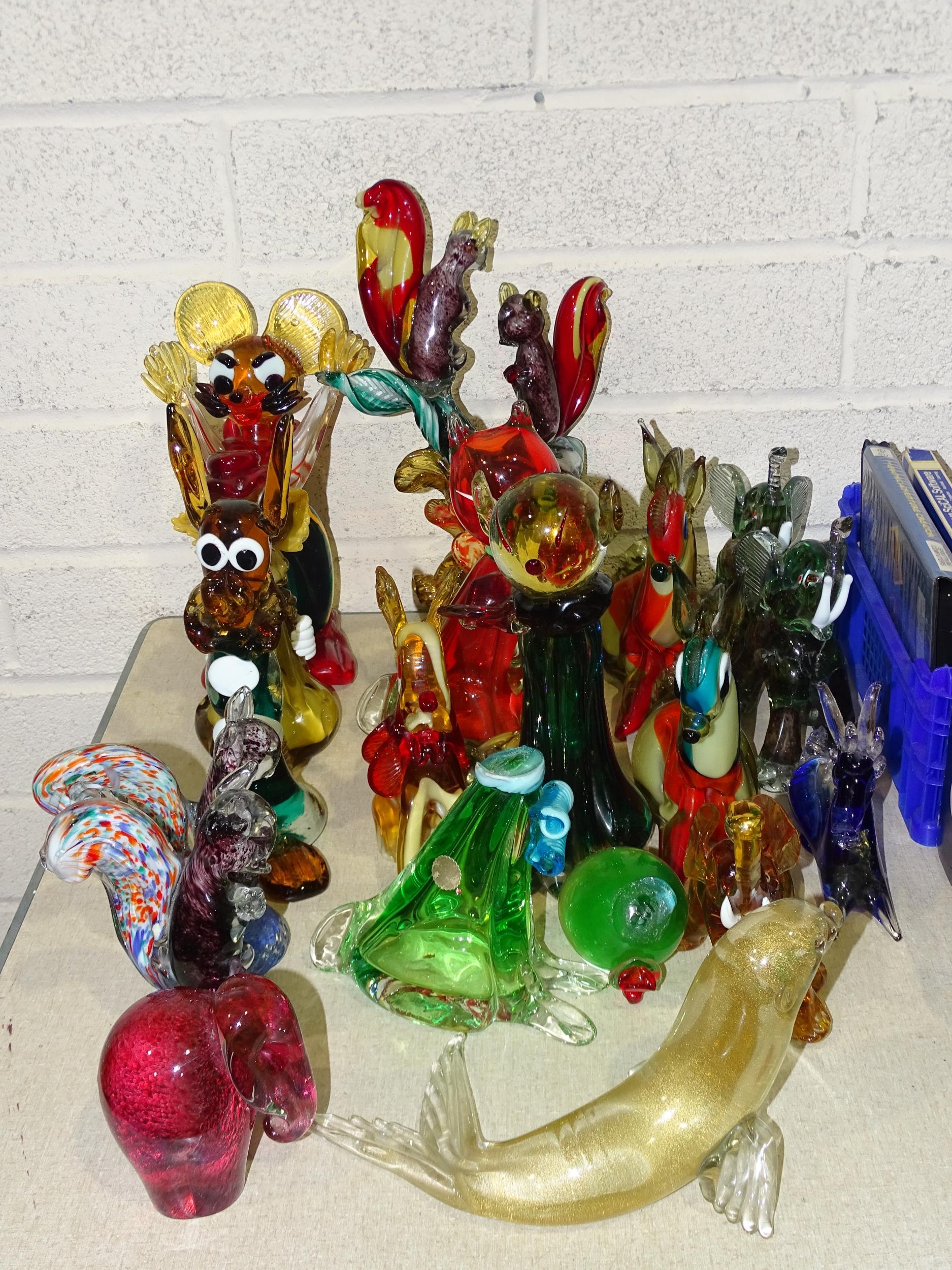A collection of eighteen Murano and other glass animal figures, including squirrels, elephants,