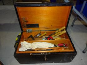 A small stained wood tool box, together with a collection of woodworking tools.