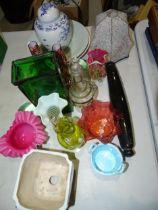 A blue and white ginger jar and cover, various coloured glassware and other ceramics.