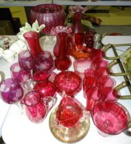 A collection of cranberry glass beakers, jugs and other glassware.