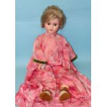 A Schoenau & Hoffmeister bisque-head doll with sleeping blue eyes, mohair wig and jointed