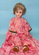 A Schoenau & Hoffmeister bisque-head doll with sleeping blue eyes, mohair wig and jointed