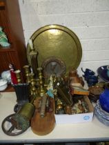 A collection of brass and other metalware, including two pairs of candlesticks, a clockwork roasting