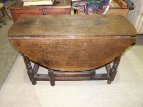 An antique oak drop-leaf dining table, 122 x 132cm open.