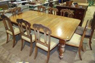 A Victorian 'pull-out' extending dining table, 122 x 210cm and a set of nine oak dining chairs