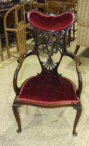 An Edwardian stained wood armchair in the American taste.