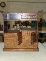 An early-20th century Japanese parquetry collector's chest with an arrangement of drawers, shelves