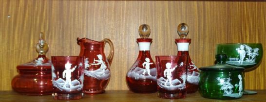 Six pieces of cranberry glass with Mary Gregory-style decoration, together with two pieces of