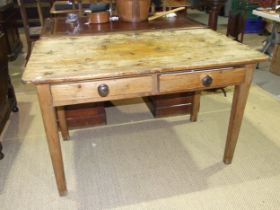 A 19th century pine scrub-top kitchen table having a pair of frieze drawers, on square tapered legs,