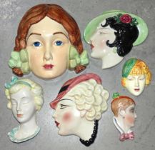 A Beswick pottery face mask of a young girl with plaits, impressed 393, 20 x 20.5cm and five other