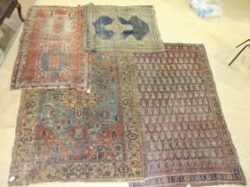 Four worn Oriental rugs, (first half of 20th century), 136 x 209cm, 148 x 200cm, 100 x 158cm and 102
