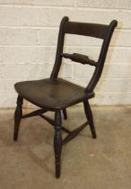 A child's stained wood chair, the back with central turned bar, on solid seat with turned legs, 64cm