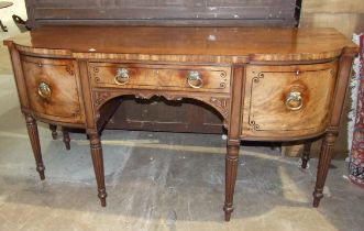 A George IV ebony inlaid mahogany breakfront sideboard, the central drawer flanked by a cupboard