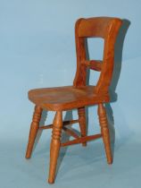 A model of a rope-back kitchen chair, 30cm high, possibly an apprentice piece.