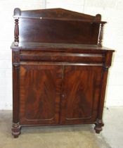 An early-19th century mahogany chiffonier, the shelved back above a frieze drawer and two cupboard