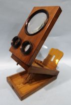 A mahogany or walnut stereo-graphoscope with three lenses and folding viewing box.