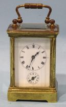 A late-19th/early-20th century brass miniature carriage alarm clock, the white enamel face with dial