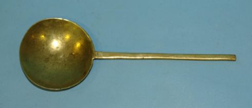 A 17th century brass spoon with indistinct stamp mark, 22.5cm long, 7.5cm diameter, together with