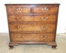 A George III mahogany crossbanded chest of two short and three long drawers, on ogee bracket feet,