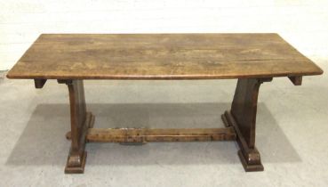 A large chestnut refectory-style table, the four-planked top on solid end supports joined by