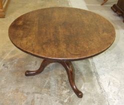 An antique oak tripod table, cut-down to form a coffee table, 80cm diameter.
