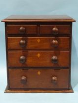 A mahogany miniature chest of two short and three long drawers, 37cm wide, 40cm high.