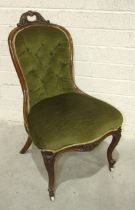 A Victorian walnut low salon chair, with carved frame and serpentine seat.