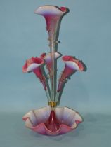 A late-19th century pink and opaline glass epergne, the central trumpet vase flanked by three