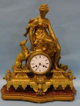 A Victorian gilt spelter mantel clock, the central drum shape clock movement, with enamel dial