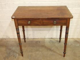 A George IV ebony inlaid mahogany two-drawer side table on ring-turned legs, 82cm wide, 48cm deep,