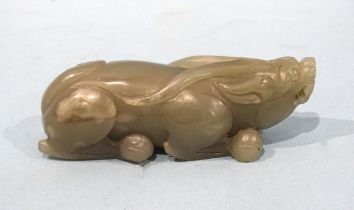 A jade stylised model of a water buffalo crouching on its haunches, 9.5cm long.