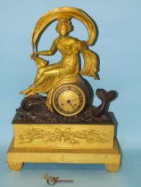 An early-19th century gilt and bronzed metal mantel clock in the form of Aphrodite riding a dolphin,