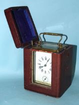 An early-20th century French brass carriage clock, the white enamel face having Roman numerals above