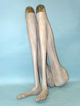 A pair of painted carved wood human legs and feet, 100cm high, (appear to have been used as table