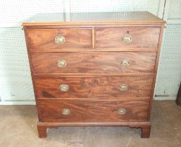 An early-19th century mahogany rectangular chest of two short and three long cockbeaded drawers,