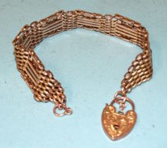 An unusual 9ct rose gold gate-link bracelet with smooth and textured links, inset yellow gold knot